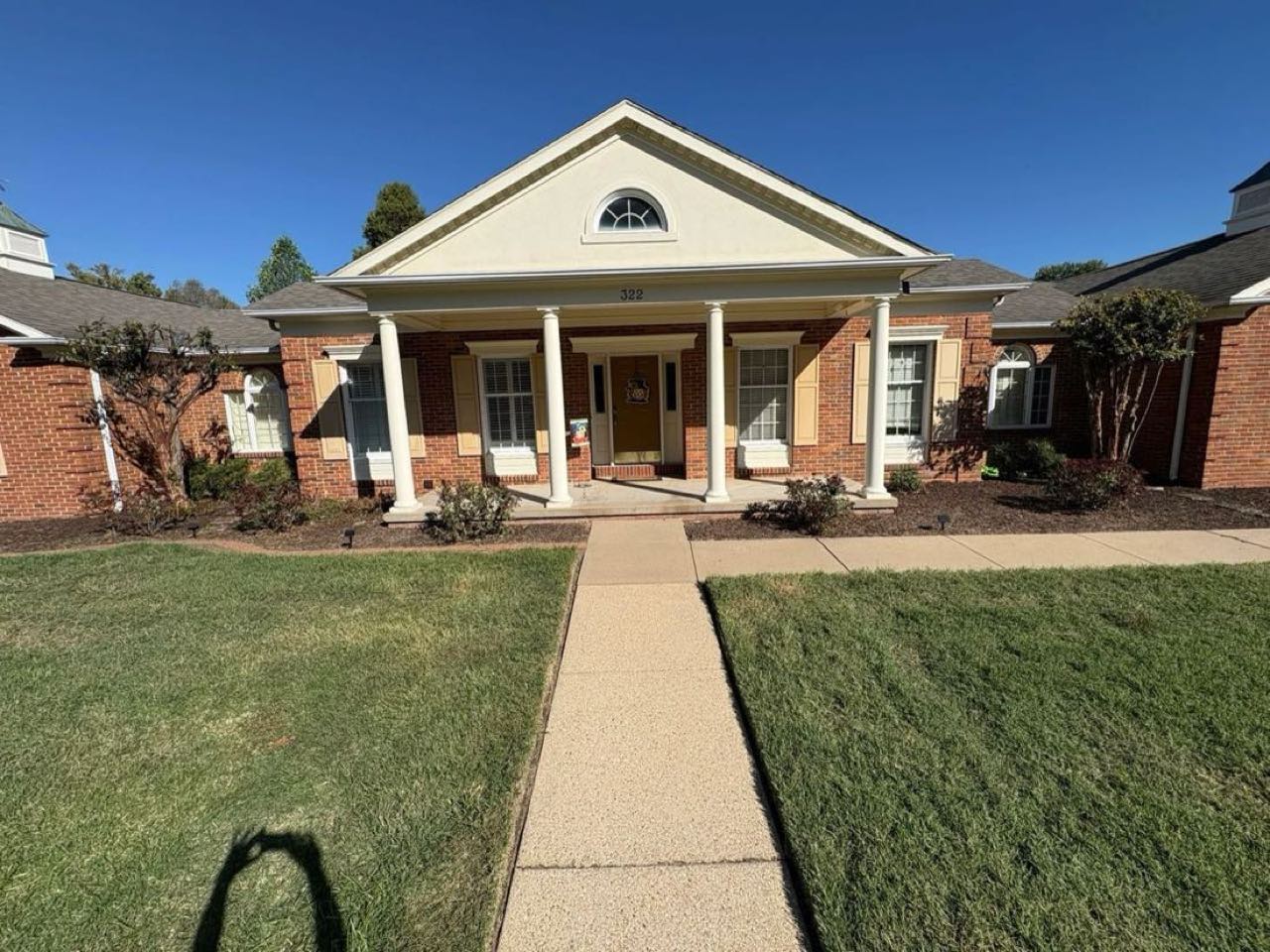 Manicured front lawn and landscape beds at a Sikeston home