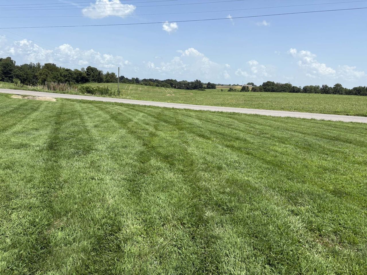 Wide striped lawn along a country property